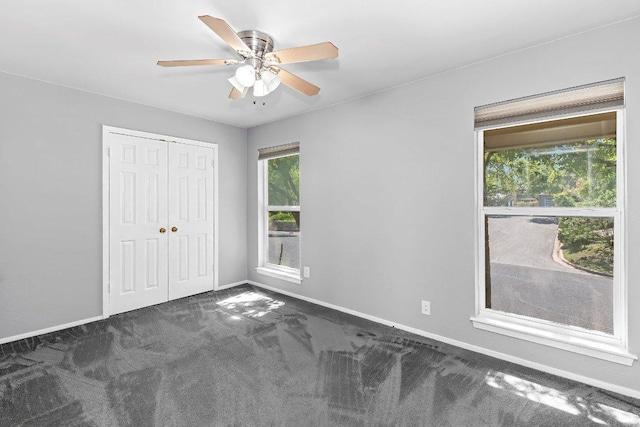 6013 Mountain Villa Dr, Austin, TX 78731 - unfurnished bedroom with carpet, baseboards, a closet, and a ceiling fan
