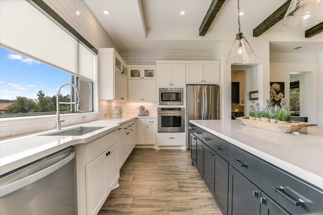 518 Doe Whisper Way, Austin, TX 78738 - kitchen with appliances with stainless steel finishes, white cabinetry, light countertops, pendant lighting, and recessed lighting