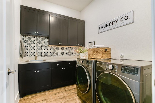 518 Doe Whisper Way, Austin, TX 78738 - laundry area with cabinet space, washing machine and dryer, and light wood-style floors