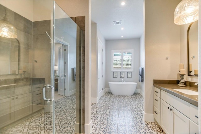 518 Doe Whisper Way, Austin, TX 78738 - full bath featuring vanity, a shower stall, a soaking tub, tile patterned flooring, and recessed lighting