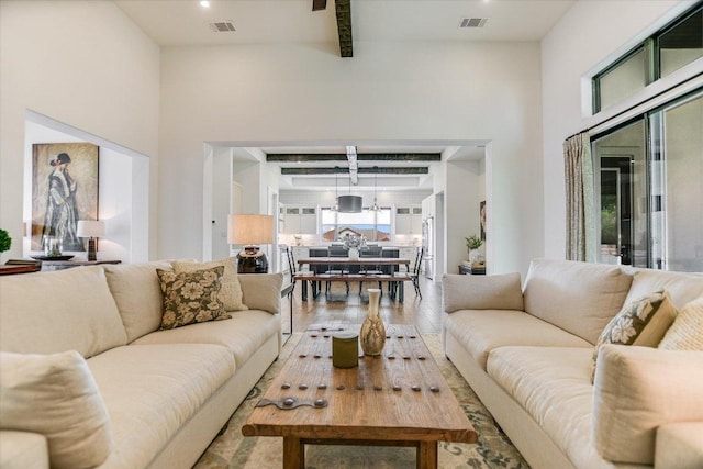 518 Doe Whisper Way, Austin, TX 78738 - living area with wood-type flooring, beamed ceiling, and a high ceiling