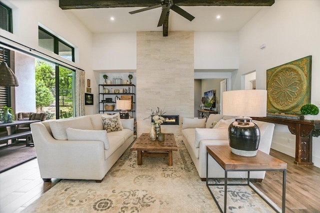 518 Doe Whisper Way, Austin, TX 78738 - living area featuring a high ceiling, wood finished floors, ceiling fan, a tile fireplace, and recessed lighting