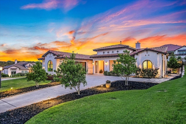 518 Doe Whisper Way, Austin, TX 78738 - mediterranean / spanish-style home with driveway, an attached garage, stucco siding, a front lawn, and a tile roof