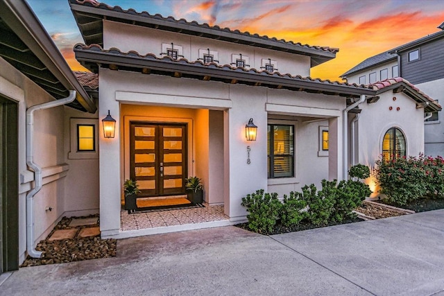 518 Doe Whisper Way, Austin, TX 78738 - exterior entry at dusk featuring stucco siding