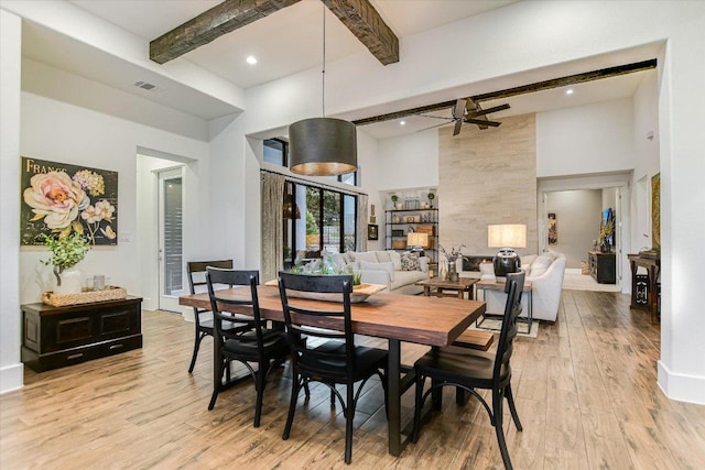 518 Doe Whisper Way, Austin, TX 78738 - dining space featuring a towering ceiling, light wood-style floors, beam ceiling, ceiling fan, and recessed lighting
