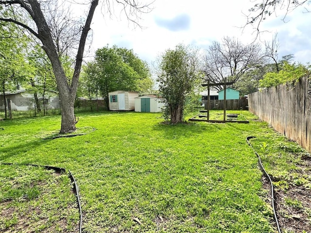 716 Barbara Dr, San Marcos, TX 78666 - view of yard with an outbuilding, a storage unit, and a fenced backyard