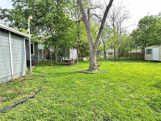 716 Barbara Dr, San Marcos, TX 78666 - view of yard with a shed, central air condition unit, fence, and an outbuilding