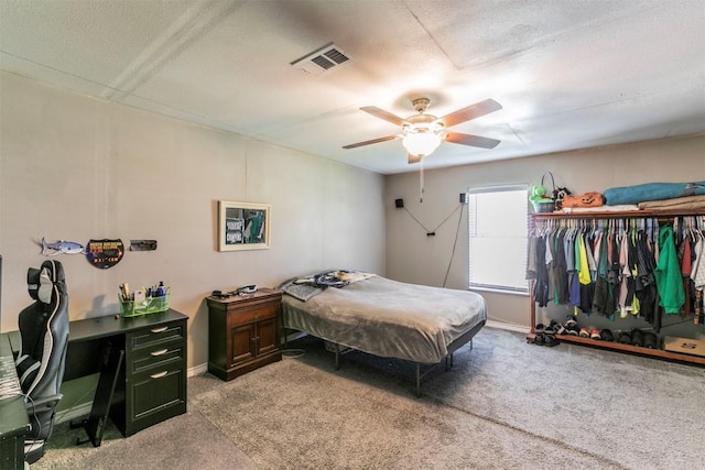 bedroom with light carpet, visible vents, baseboards, and a ceiling fan