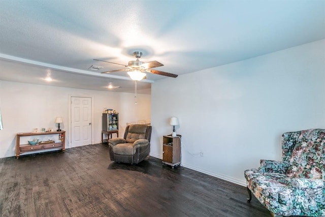 sitting room featuring visible vents, baseboards, a ceiling fan, and wood finished floors