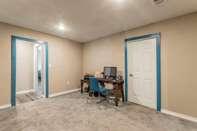 home office with baseboards, visible vents, and carpet floors