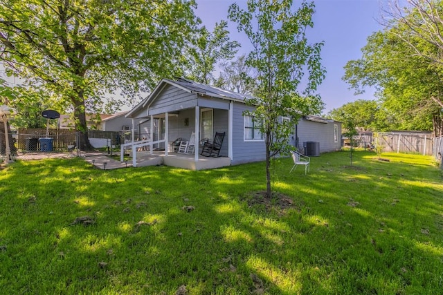 rear view of property with a yard, a patio, a fenced backyard, and cooling unit
