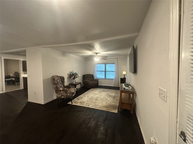 409 E Houston St, Mexia, TX 76667 - living room with ceiling fan, dark wood-type flooring, and baseboards