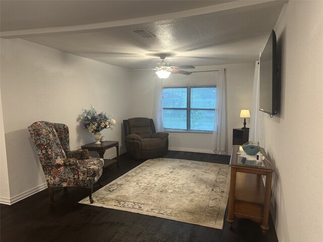 409 E Houston St, Mexia, TX 76667 - sitting room featuring wood finished floors, ceiling fan, baseboards, a textured ceiling, and a textured wall