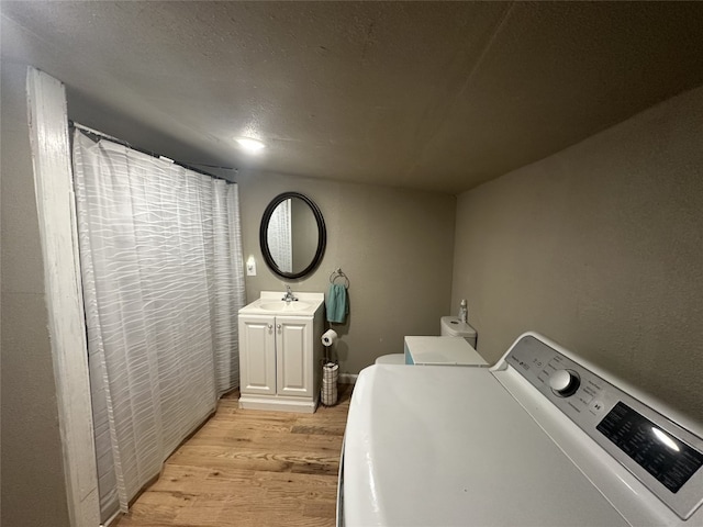 409 E Houston St, Mexia, TX 76667 - washroom with light wood-style flooring and separate washer and dryer