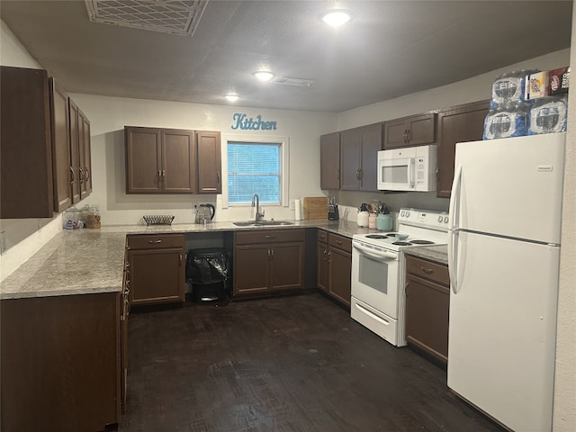409 E Houston St, Mexia, TX 76667 - kitchen featuring white appliances, a sink, and dark wood-style flooring