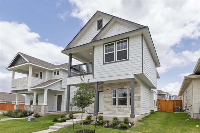 124 Rollingwood Dr, San Marcos, TX 78666 - view of front of house featuring stone siding, a balcony, and a porch