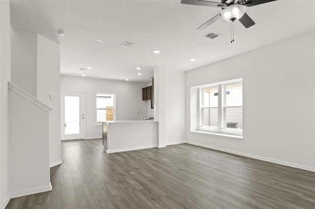 124 Rollingwood Dr, San Marcos, TX 78666 - unfurnished living room with a ceiling fan, dark wood-style flooring, baseboards, recessed lighting, and a sink