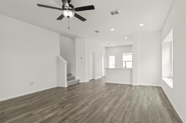 124 Rollingwood Dr, San Marcos, TX 78666 - unfurnished living room with stairs, dark wood-style floors, recessed lighting, ceiling fan, and baseboards