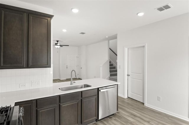 124 Rollingwood Dr, San Marcos, TX 78666 - kitchen featuring dishwasher, a sink, dark brown cabinets, ceiling fan, and range with gas stovetop