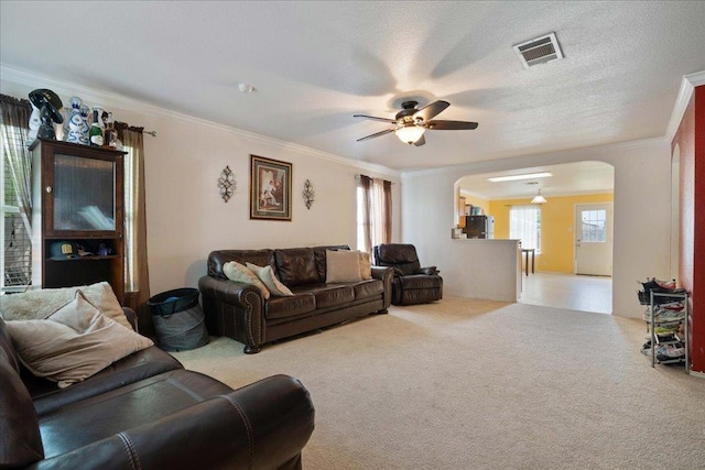 4003 Reeders Dr, Austin, TX 78725 - living room with arched walkways, ceiling fan, carpet floors, and crown molding
