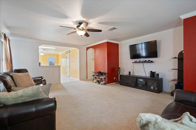 4003 Reeders Dr, Austin, TX 78725 - living area featuring arched walkways, ceiling fan, ornamental molding, and carpet flooring