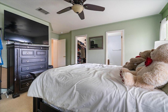 4003 Reeders Dr, Austin, TX 78725 - bedroom featuring light carpet, a walk in closet, a closet, a ceiling fan, and ensuite bath