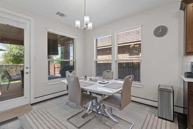 104 Atlanta Park Dr, Georgetown, TX 78628 - dining area with healthy amount of natural light, a chandelier, baseboard heating, and light colored carpet