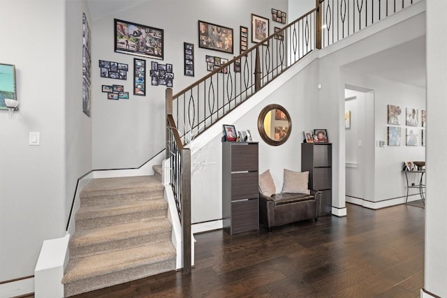 104 Atlanta Park Dr, Georgetown, TX 78628 - stairs with wood finished floors, a towering ceiling, and baseboards