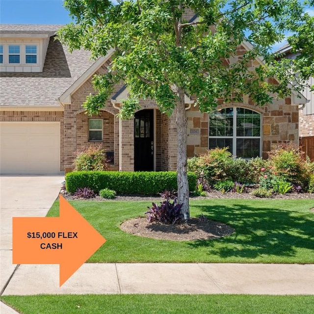 104 Atlanta Park Dr, Georgetown, TX 78628 - view of front of property with a front lawn, brick siding, roof with shingles, and driveway