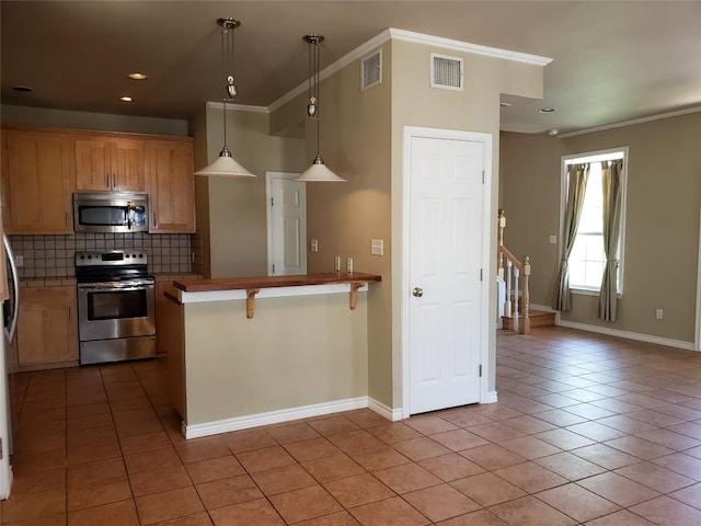 kitchen with crown molding, visible vents, appliances with stainless steel finishes, light tile patterned flooring, and backsplash