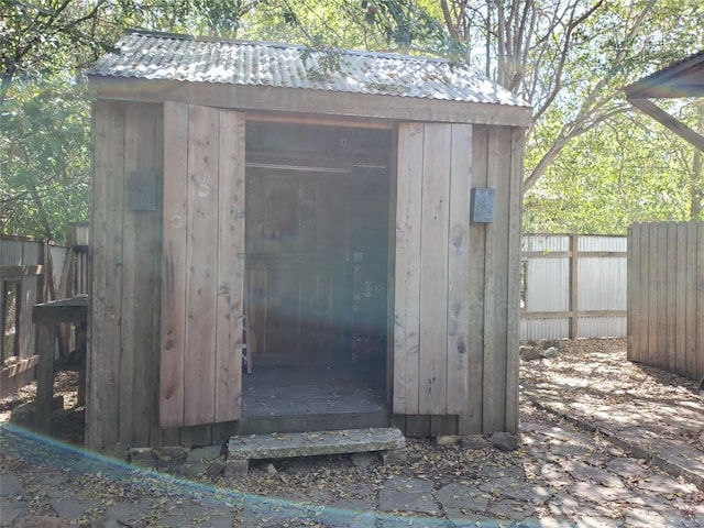 view of shed with fence