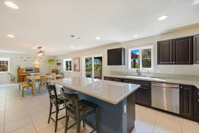 11208 Mickelson Dr, Austin, TX 78747 - kitchen featuring dishwasher, light tile patterned floors, healthy amount of natural light, and recessed lighting