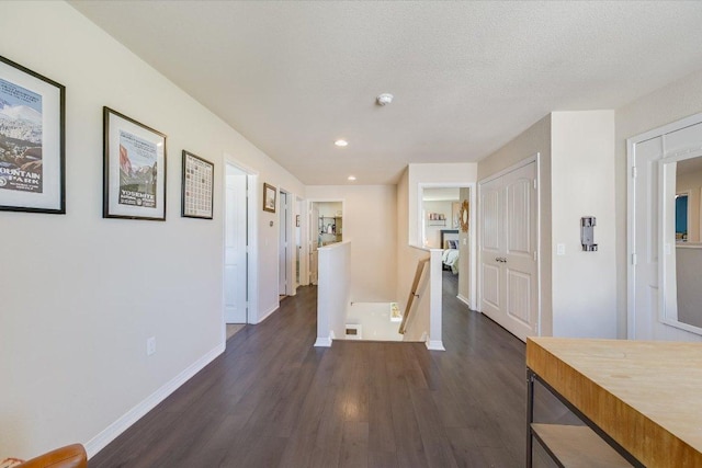 11208 Mickelson Dr, Austin, TX 78747 - hall with an upstairs landing, dark wood-type flooring, and recessed lighting