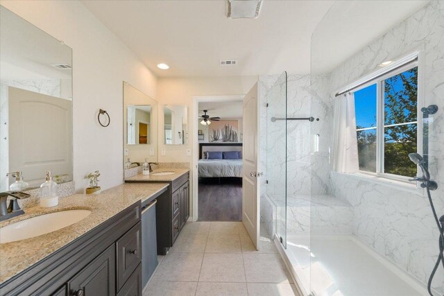 11208 Mickelson Dr, Austin, TX 78747 - full bathroom featuring vanity, a marble finish shower, ensuite bathroom, ceiling fan, and tile patterned floors