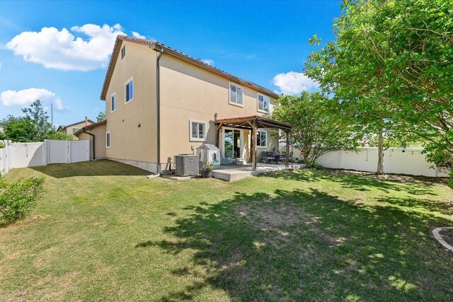 11208 Mickelson Dr, Austin, TX 78747 - rear view of house with a pergola, a patio, a fenced backyard, and stucco siding