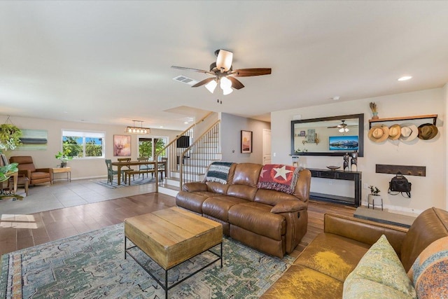 11208 Mickelson Dr, Austin, TX 78747 - living room featuring wood finished floors, ceiling fan, stairway, and recessed lighting
