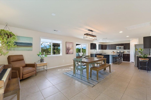 11208 Mickelson Dr, Austin, TX 78747 - dining space featuring light tile patterned floors and recessed lighting