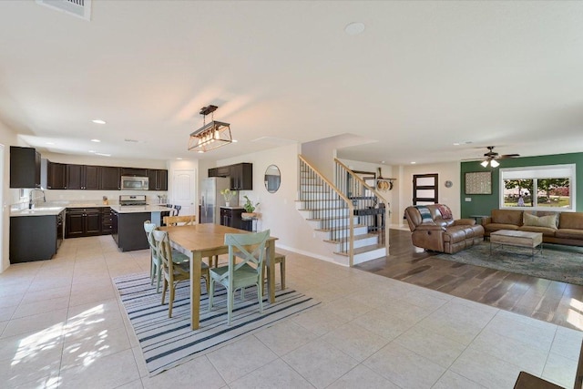 11208 Mickelson Dr, Austin, TX 78747 - dining room with light tile patterned flooring, stairs, recessed lighting, and a ceiling fan