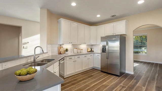 12325 Labrador Bay Ct, Austin, TX 78732 - kitchen with stainless steel appliances, a sink, white cabinetry, decorative backsplash, and recessed lighting