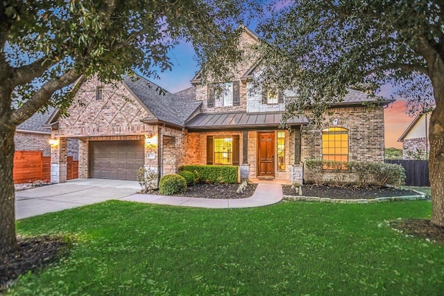 12325 Labrador Bay Ct, Austin, TX 78732 - view of front of property with driveway, a standing seam roof, a garage, and brick siding