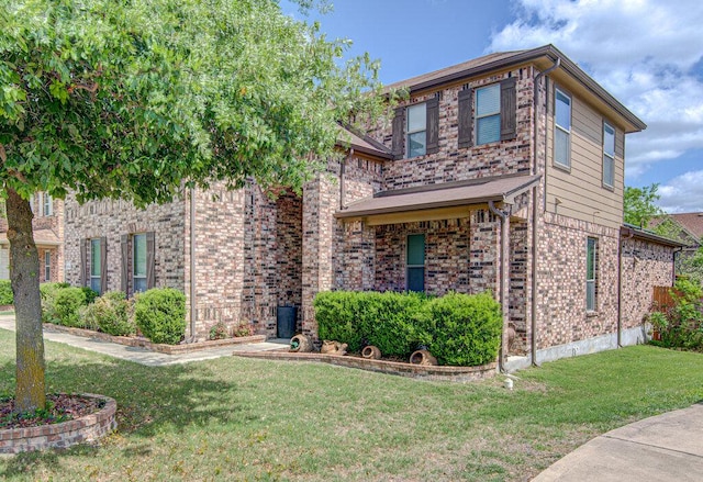 traditional-style home with a front lawn and brick siding