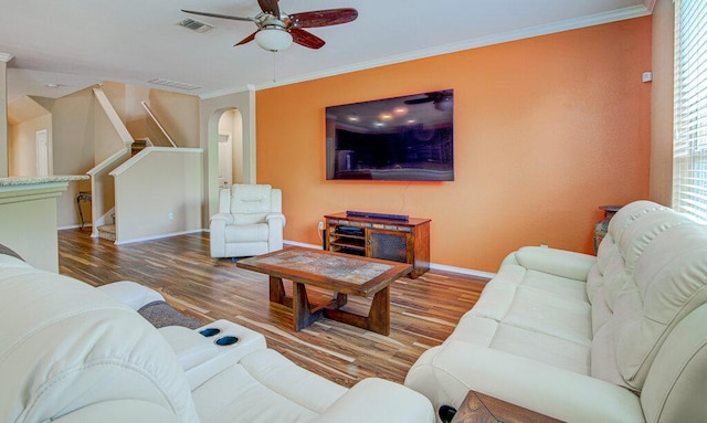 living room with baseboards, wood finished floors, visible vents, and ceiling fan