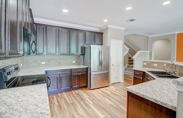 kitchen with stainless steel appliances, visible vents, a sink, and crown molding