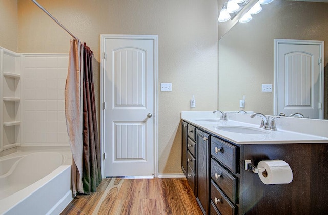 full bath featuring shower / bath combination with curtain, wood finished floors, a sink, and double vanity