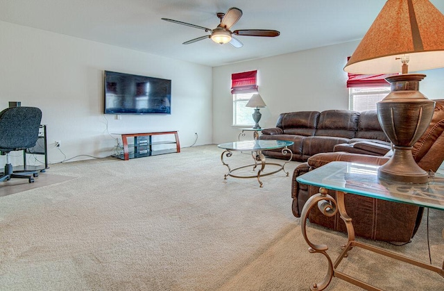 carpeted living room with ceiling fan