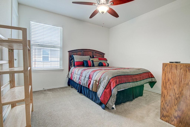 bedroom featuring a ceiling fan, baseboards, and carpet