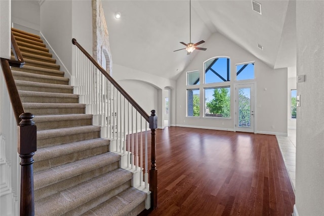 118 Bluehaw Dr, Georgetown, TX 78628 - stairway featuring high vaulted ceiling, ceiling fan, wood finished floors, arched walkways, and baseboards