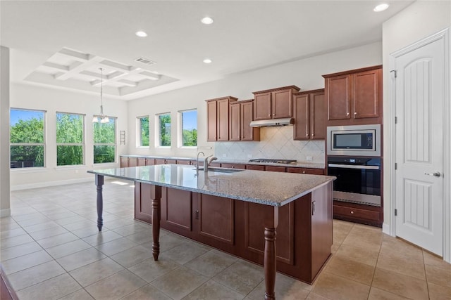 118 Bluehaw Dr, Georgetown, TX 78628 - kitchen with appliances with stainless steel finishes, recessed lighting, decorative backsplash, under cabinet range hood, and a sink