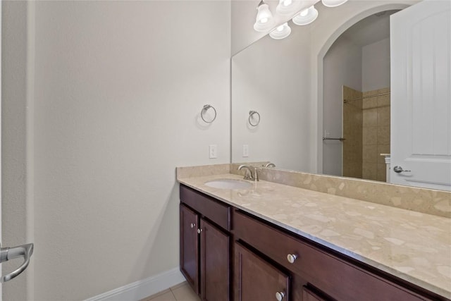 118 Bluehaw Dr, Georgetown, TX 78628 - bathroom with vanity, baseboards, tiled shower, and tile patterned floors