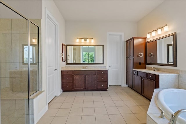 118 Bluehaw Dr, Georgetown, TX 78628 - bathroom with a stall shower, a bath, two vanities, and tile patterned floors